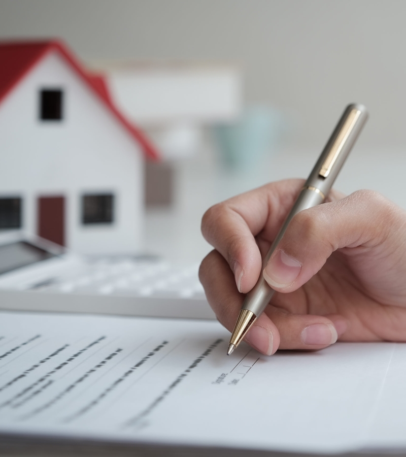 Customers are reading loan and insurance agreement documents to sign real estate transactions.